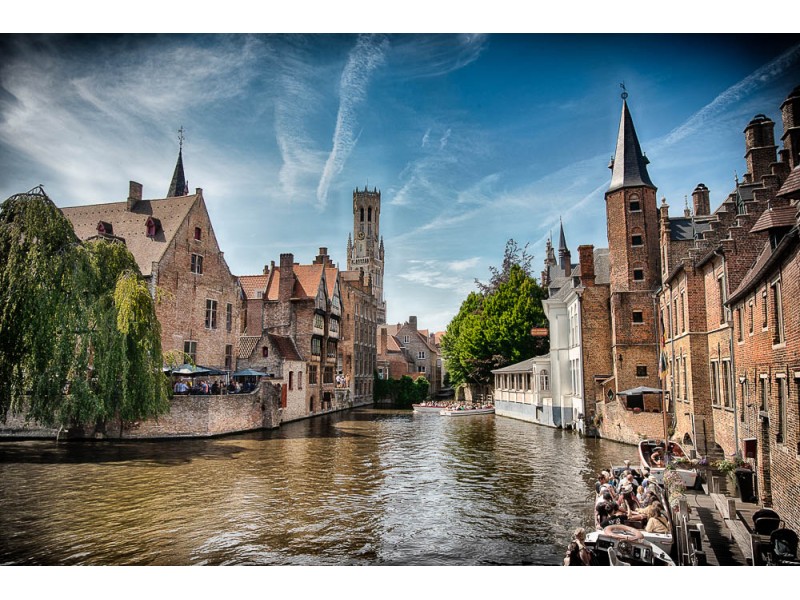View of the Belfry in Brugge with canal in foreground