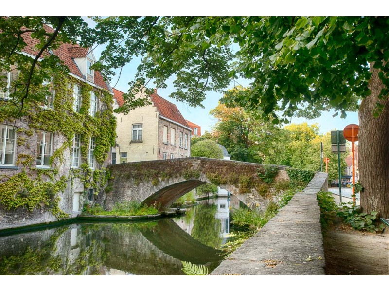 Stone arch Peerdenbridge over the Groenerij Canal in Bruges Belgium