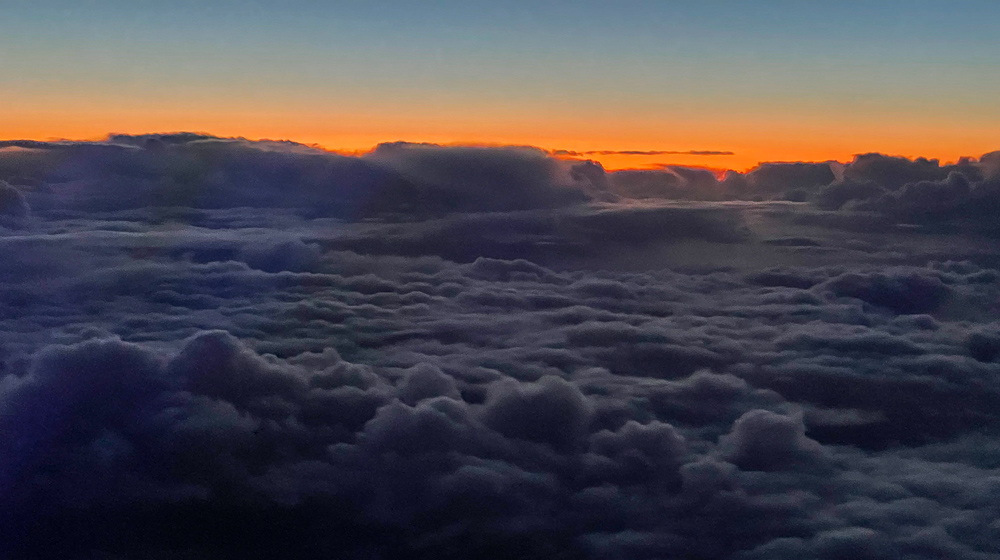 above the clouds with sky orange sunset colors