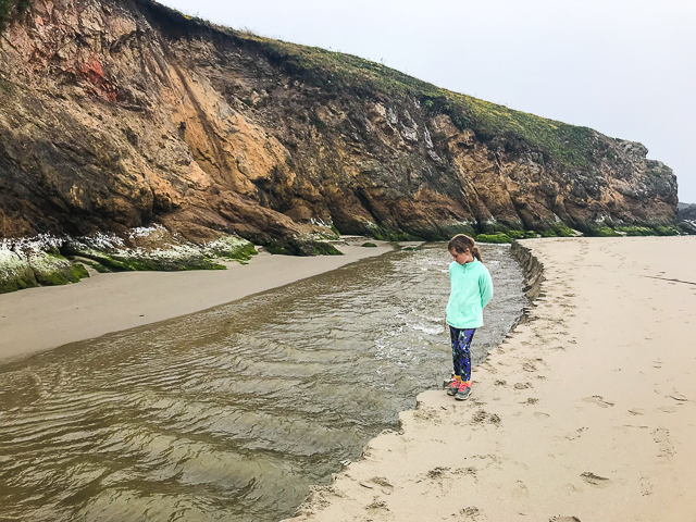 katie next to river on sand
