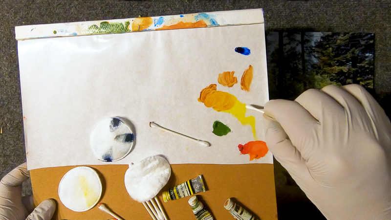 mixing burnt sienna and yellow to create yellow ochre