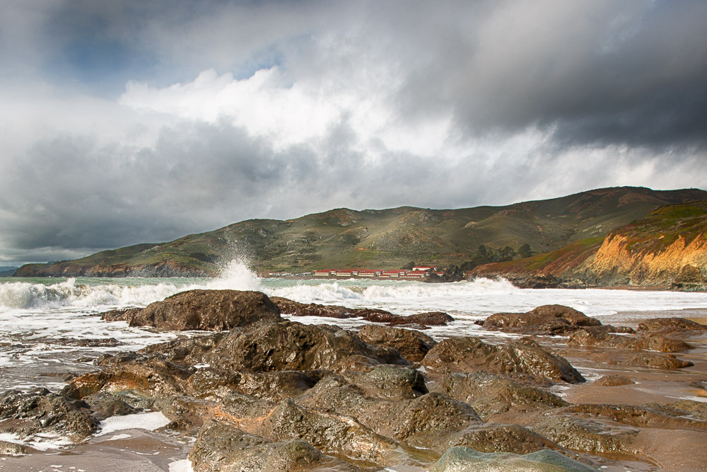 rocks and waves at south rodeo beach with fort cronkhite in background