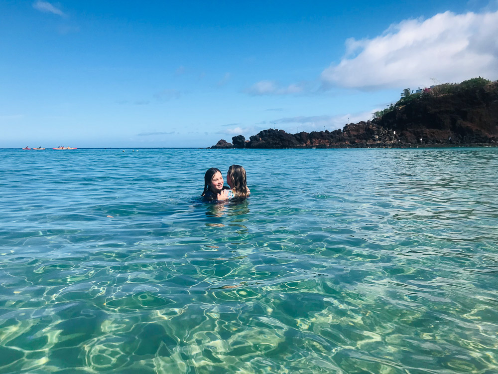 two girls in the ocean at black rock maui
