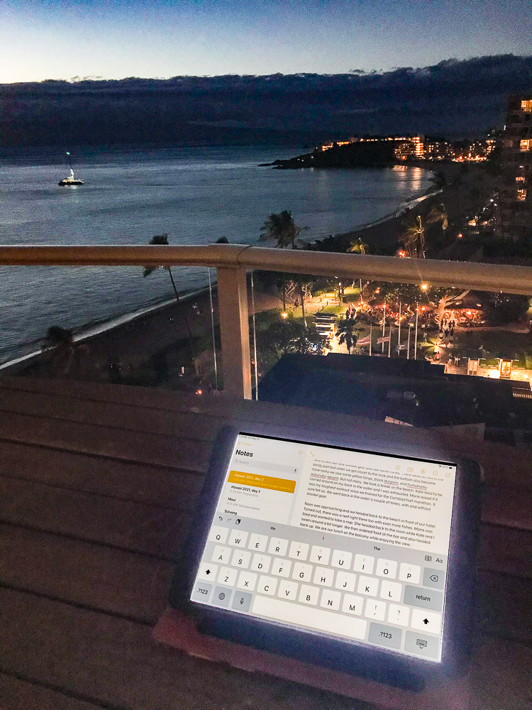 writing on ipad at balcony maui